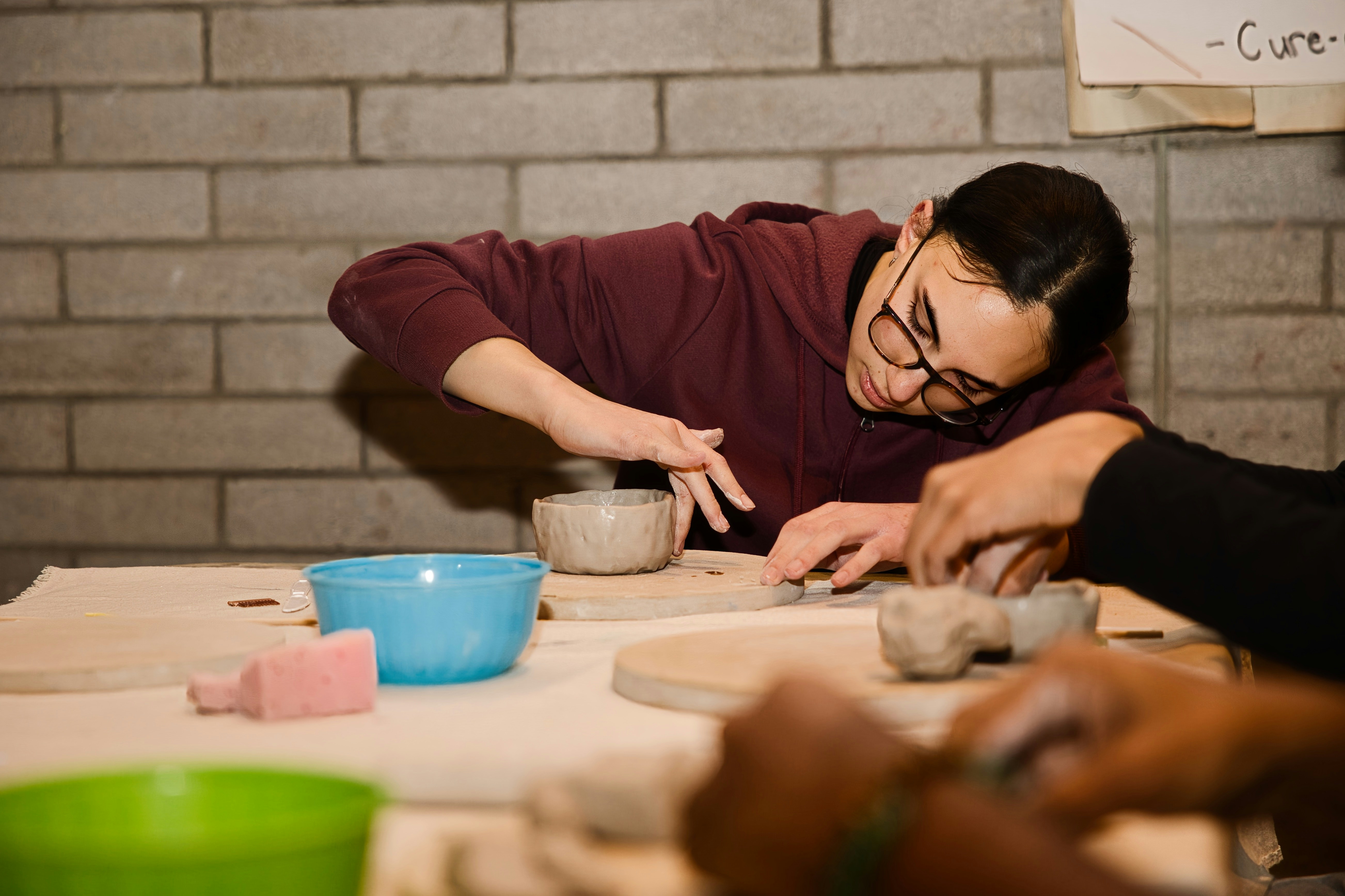 Students learning hand-building pottery
