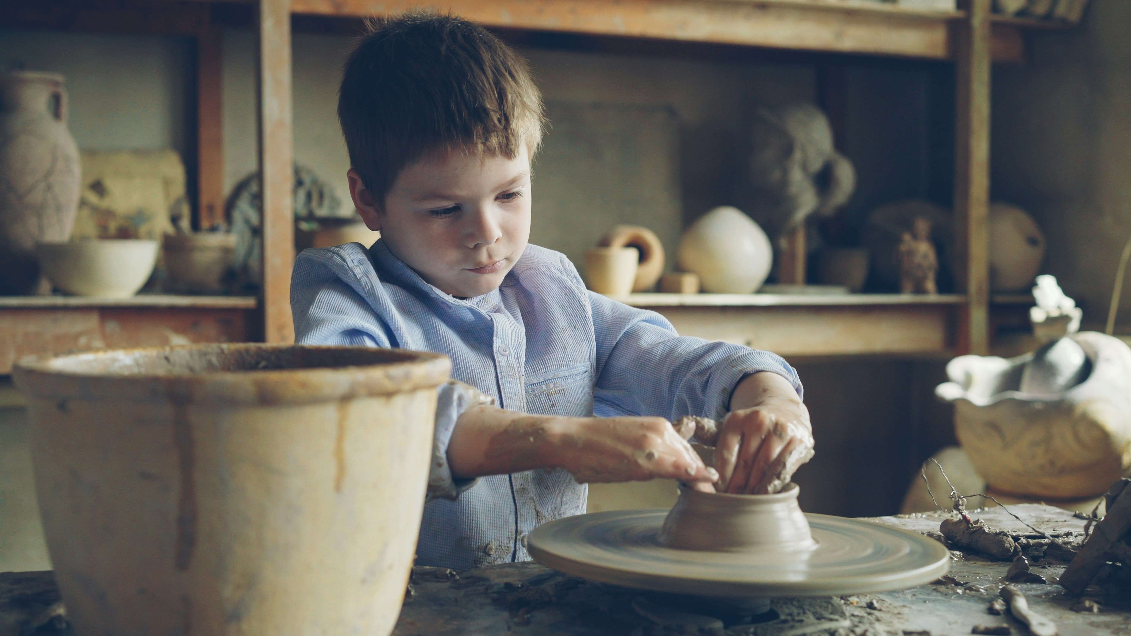 Students learning wheel throwing pottery